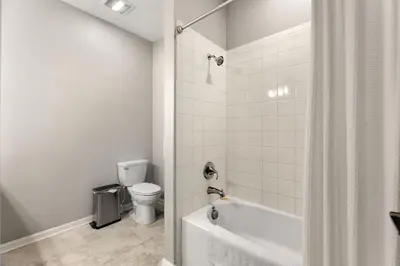 a bathroom with a white tub and a toilet at Fireworks Night -Storey Lake By Shine Villas #709 in Kissimmee