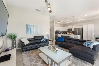 a living room with a couch and a table at Fireworks Night -Storey Lake By Shine Villas #709 in Kissimmee