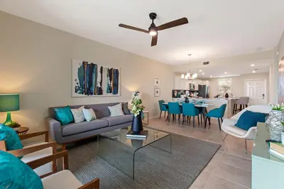 a living room with a couch and a table at Resort Life At Storey Lake By Shine Villas #702 in Kissimmee
