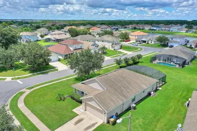 an aerial view of a home in a residential neighborhood at Gilded Parasol By Shine Villas Remington Golf 420 in Kissimmee