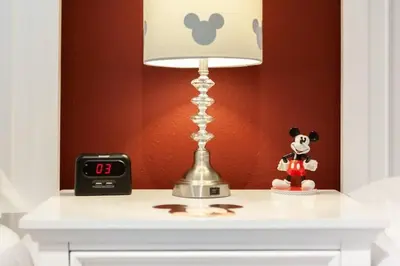 a table with a lamp and a clock on it at Enjoy a Cozy 3 BR/Clubhouse/Near Disney and more in Kissimmee