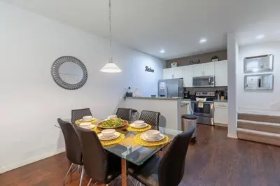a dining room and kitchen with a table and chairs at Enjoy a Cozy 3 BR/Clubhouse/Near Disney and more in Kissimmee