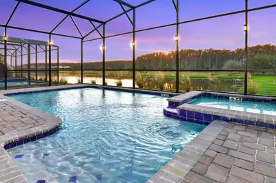a swimming pool in a building with a view at Luxury 9BR Gem- Heated Pool, Theater & Theme Rooms in Kissimmee