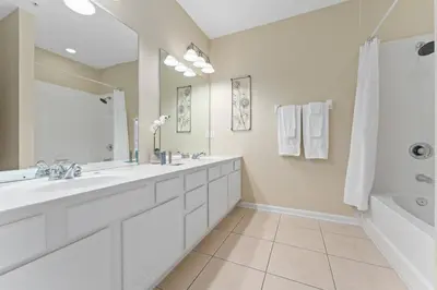 a bathroom with two sinks and a large mirror at Luxury 3-Suite Townhome Resort Near Universal in Orlando