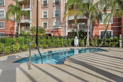 a swimming pool in front of a building at Luxury 3-Suite Townhome Resort Near Universal in Orlando