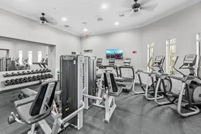a gym with cardio equipment and treadmills at Luxury 3-Suite Townhome Resort Near Universal in Orlando