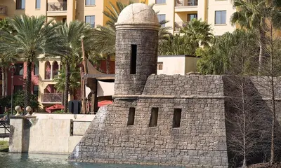 a stone tower in the middle of the water at Bonnet Creek Resort 1 Bedroom 1 BA Deluxe Villa in Orlando