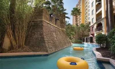 a pool with two inflatable tubes in the water at Bonnet Creek Resort 1 Bedroom 1 BA Deluxe Villa in Orlando