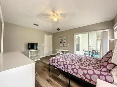 a bedroom with a bed with a purple blanket at Four Bed Three Bath in a gated community with pool in Kissimmee