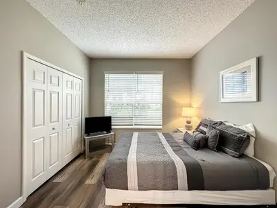 a bedroom with a bed and a television in it at Four Bed Three Bath in a gated community with pool in Kissimmee