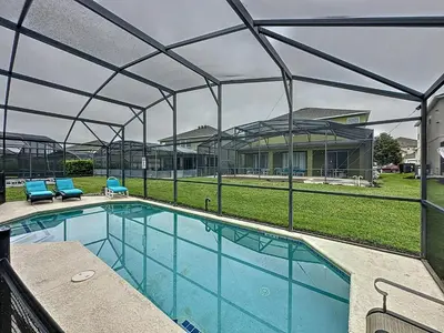 a swimming pool with a canopy over it at Four Bed Three Bath in a gated community with pool in Kissimmee