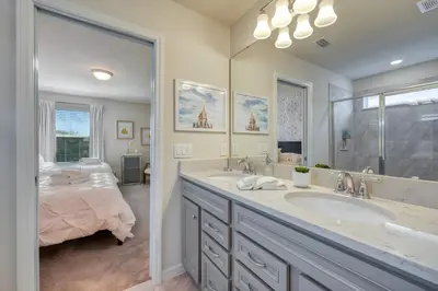 a bathroom with a sink and a bed in a room at DLuxx Summer Vacation Home at Solterra Resort 7391 in Orlando
