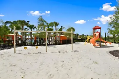 a playground with a slide and a play structure at DLuxx Summer Vacation Home at Solterra Resort 7391 in Orlando
