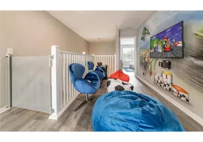 a room with a blue bean bag chair and a tv at The Minions Mansion 6br Resort Pool Home By Disney in Kissimmee