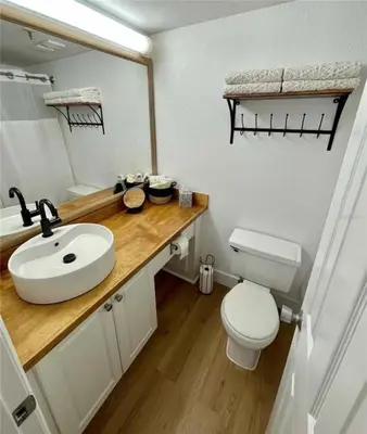 a bathroom with a sink and a toilet and a mirror at Universal-Disney Dream 1211 Studio - The Enclave in Orlando