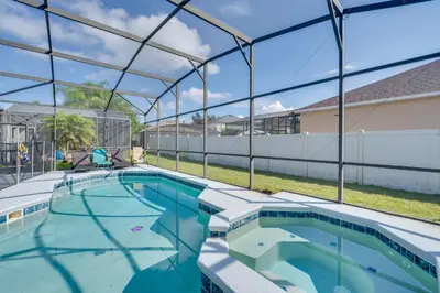 a large swimming pool with a clear cover over it at 22 Mi to Disney Kissimmee Home with Pool and Hot Tub in Kissimmee
