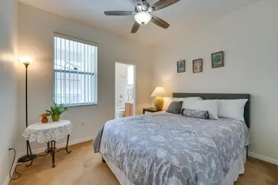 a bedroom with a bed and a ceiling fan at 22 Mi to Disney Kissimmee Home with Pool and Hot Tub in Kissimmee