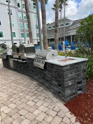 a stone wall with a grill in front of a building at Resort Family condo near Disney Pool view Free parks shuttle in Orlando