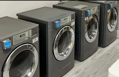 a group of three washing machines sitting next to each other at Resort Family condo near Disney Pool view Free parks shuttle in Orlando