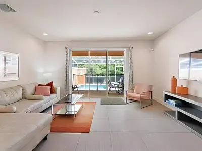 a living room with a couch and a table at MEMO Vacation House in Orlando