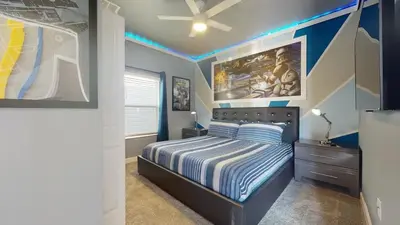 a bedroom with a bed and a ceiling fan at 4323SL-Storey Lake Resort townhouse in Kissimmee