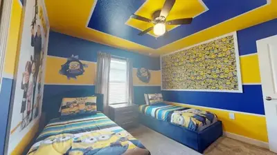 a bedroom with two beds and a ceiling fan at 4323SL-Storey Lake Resort townhouse in Kissimmee