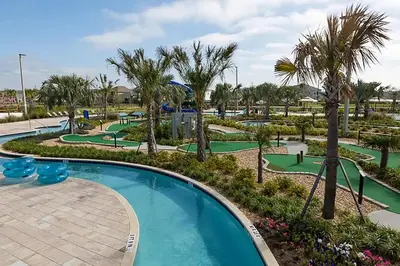 a pool at a resort with palm trees and golf carts at 4323SL-Storey Lake Resort townhouse in Kissimmee