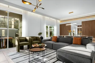 a living room with a couch and a table at 5 Bedrooms 4 Bathrooms Storey Lake 2533 Rt in Kissimmee