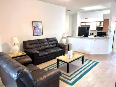 a living room with a leather couch and a coffee table at Brittany - Perfect 3 BR Pool Home in Kissimmee