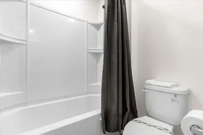 a bathroom with a shower curtain and a toilet at 6 Bedrooms 5 Bathrooms Solara 1889 Tp in Orlando