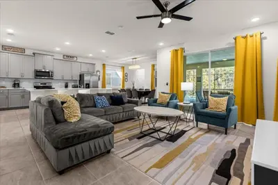a living room with a couch and a table at 6 Bedrooms 5 Bathrooms Solara 1889 Tp in Orlando