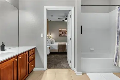 a bathroom with a sink and a shower and a bed at 3 Bedrooms 2 Bathrooms Vista Cay 4024-203 Bd in Orlando