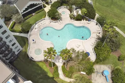 an overhead view of a swimming pool in a resort at Enclave Refurbished Condo: Just 2mi to Universal! in Orlando