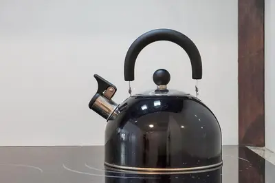 a black tea kettle sitting on a counter at Enclave Refurbished Condo: Just 2mi to Universal! in Orlando