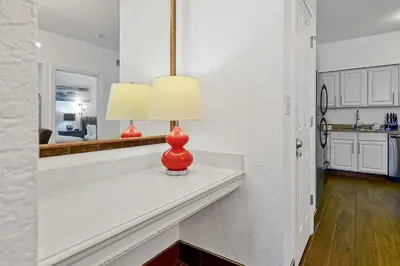 a white kitchen with a red vase on a counter at International Drive Luxury Condo in Orlando