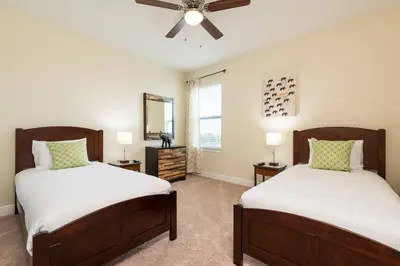 a bedroom with two beds and a ceiling fan at Reunion Encore Resort Villa W/ Pool Spa Gameroom in Orlando
