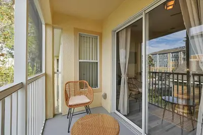a balcony with a chair and a table at Remodeled Retreat: Tranquil Resort Oasis Near Theme Parks in Kissimmee