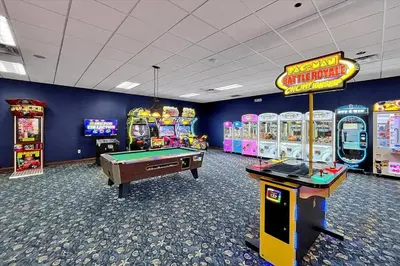 a gaming room with arcade games and a pool table at Just renovated, private heated pool, resort access in Kissimmee