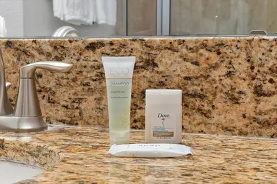 a bathroom counter with a bottle of deodorant and a container at Just renovated, private heated pool, resort access in Kissimmee