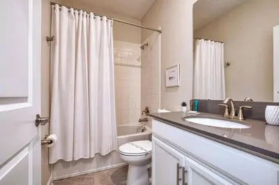 a bathroom with a toilet and a sink and a shower at Fancy Family Home 10min-Disney Private Pool STL108 in Kissimmee