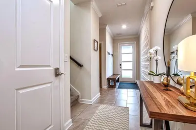 a hallway with a white door and a wooden table at Fancy Family Home 10min-Disney Private Pool STL108 in Kissimmee