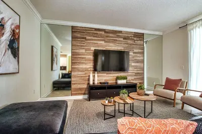 a living room with a television on a wall at Fancy Family Home 10min-Disney Private Pool STL108 in Kissimmee