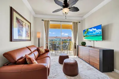 a living room with a couch and a flat screen tv at Top Floor*Balcony*VistaCay Convention Ctr & Idrive in Orlando
