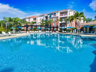 a swimming pool at a resort with palm trees and buildings at Top Floor*Balcony*VistaCay Convention Ctr & Idrive in Orlando