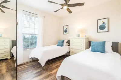 a bedroom with two beds and a mirror at Pool*Top Floor*Forest Views*Balcony*VistaCay in Orlando
