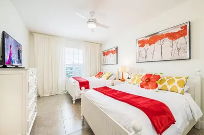 a bedroom with two beds and a tv at Top Floor*Balcony*VistaCay Convention Ctr & Idrive in Orlando