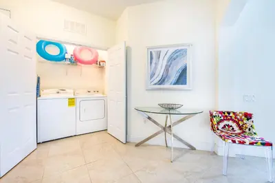 a small kitchen with a table and a chair at Top Floor*Balcony*VistaCay Convention Ctr & Idrive in Orlando