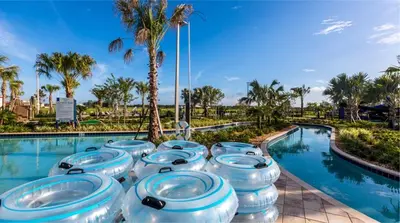 a row of blue and white toilets in front of a swimming pool at 4BR Pool Home w Free Waterpark - 9 Min to Disney in Kissimmee