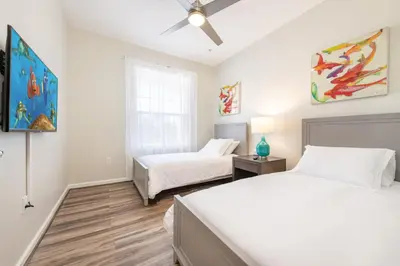 a bedroom with two beds and a ceiling fan at VistaCay Balcony near Pool Convention Ctr iDrive in Orlando