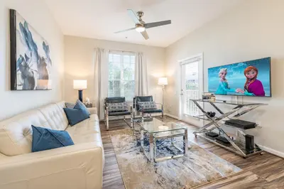 a living room with a white couch and a ceiling fan at VistaCay Balcony near Pool Convention Ctr iDrive in Orlando